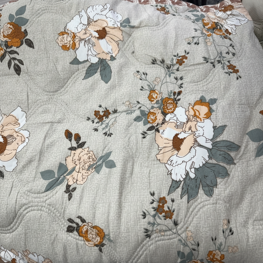Close-up of Royce Peony Garden Comforter showing peony floral print and quilted texture